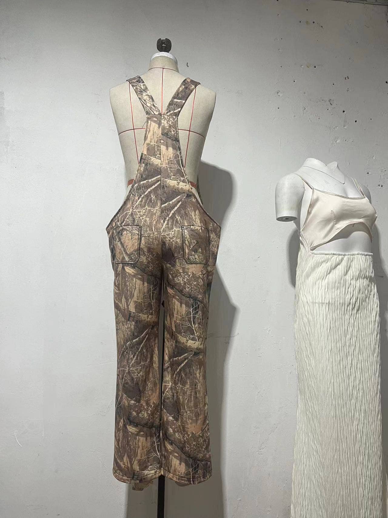 Low-rise bib jumpsuit distressed straight-leg printed pants